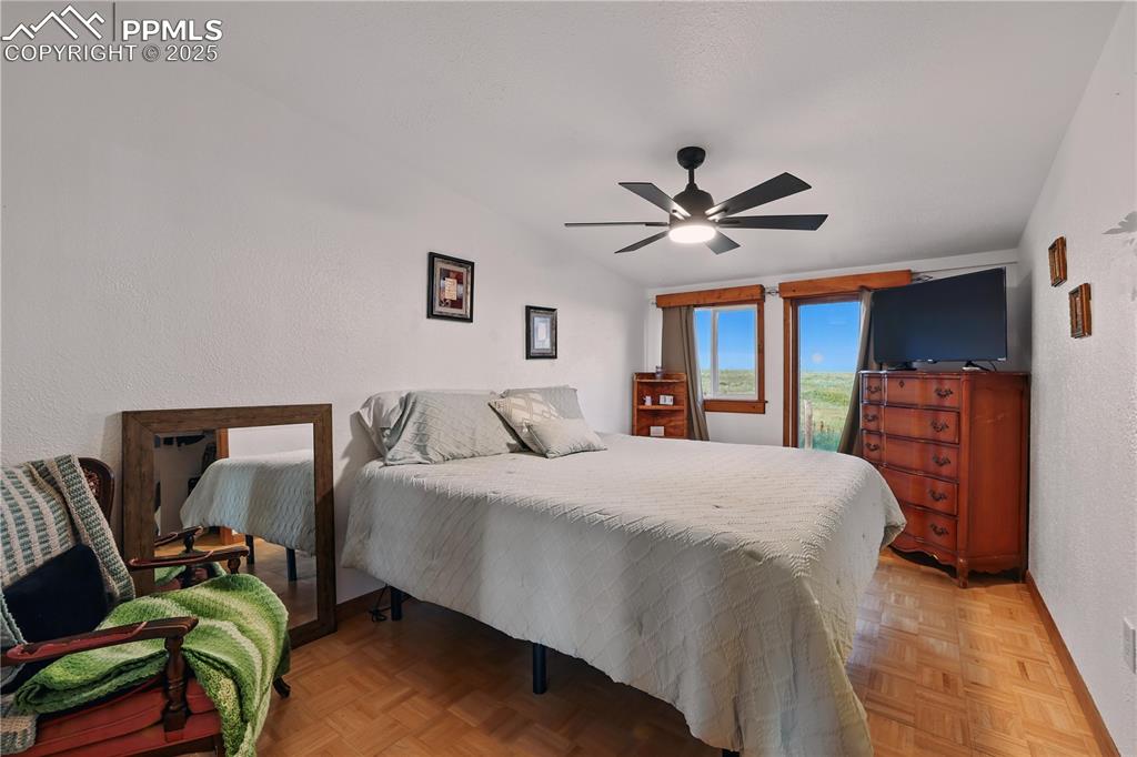 Image 28 of 50: Bedroom 2 with parquet wood floors and beautiful modern windows.