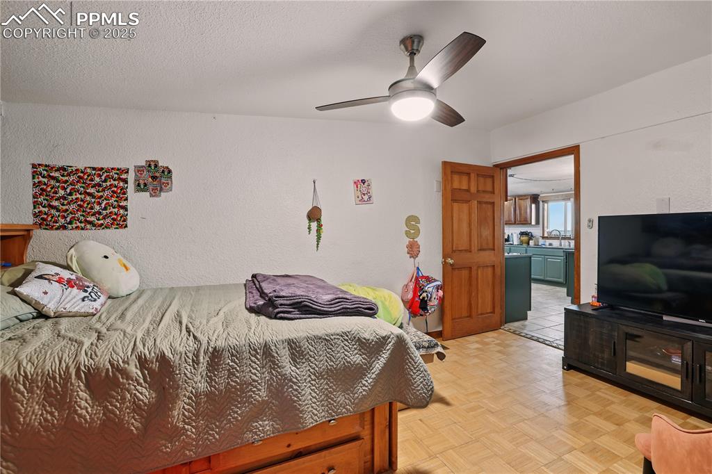 Image 36 of 50: Bedroom 4 also has a ceiling fan and plenty of room.