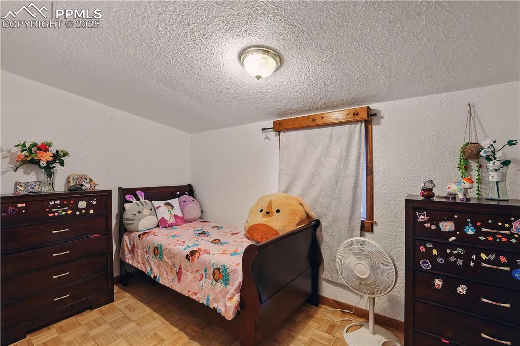 Image 37 of 50: Bedroom 5 with parquet wood floors