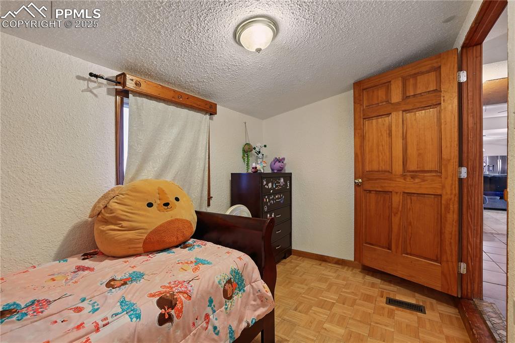 Image 38 of 50: Bedroom 5 is a cozy space that could even be a home office or playroom.