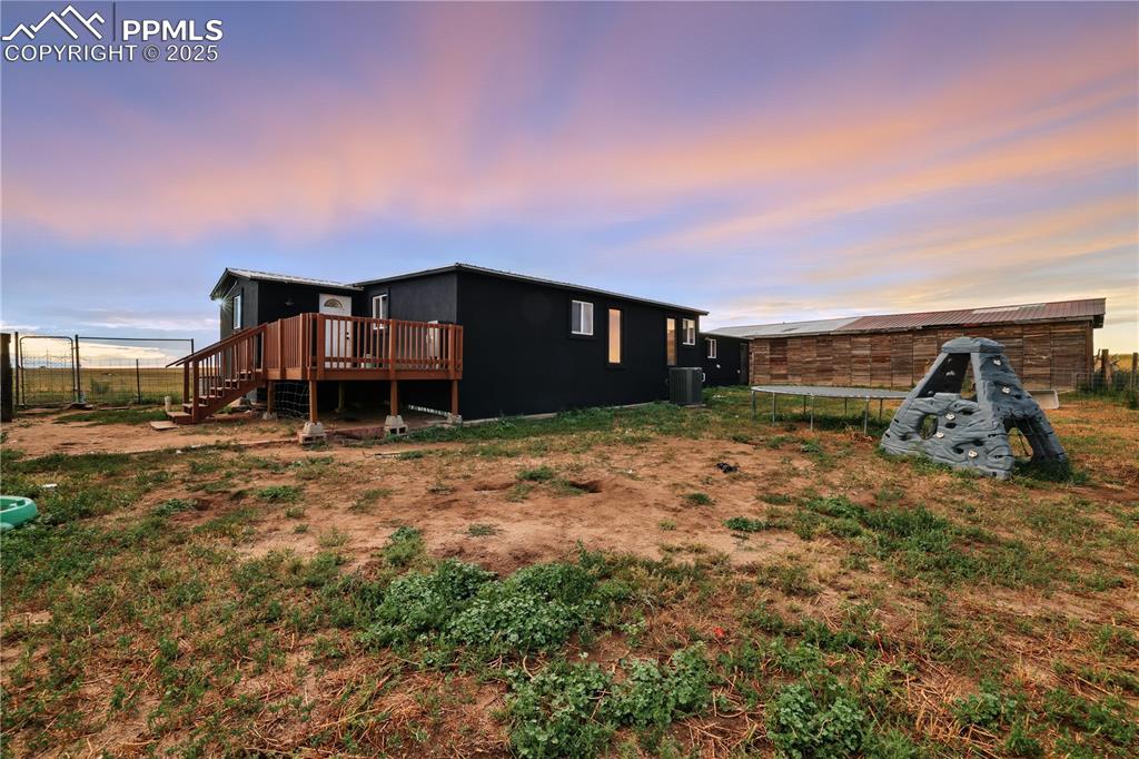 Image 41 of 50: Back of home has a deck perfect for morning coffee!