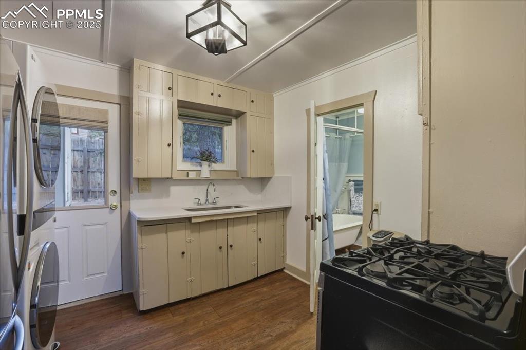 Image 15 of 47: The kitchen is located in the center of the home and has a new sink and cou