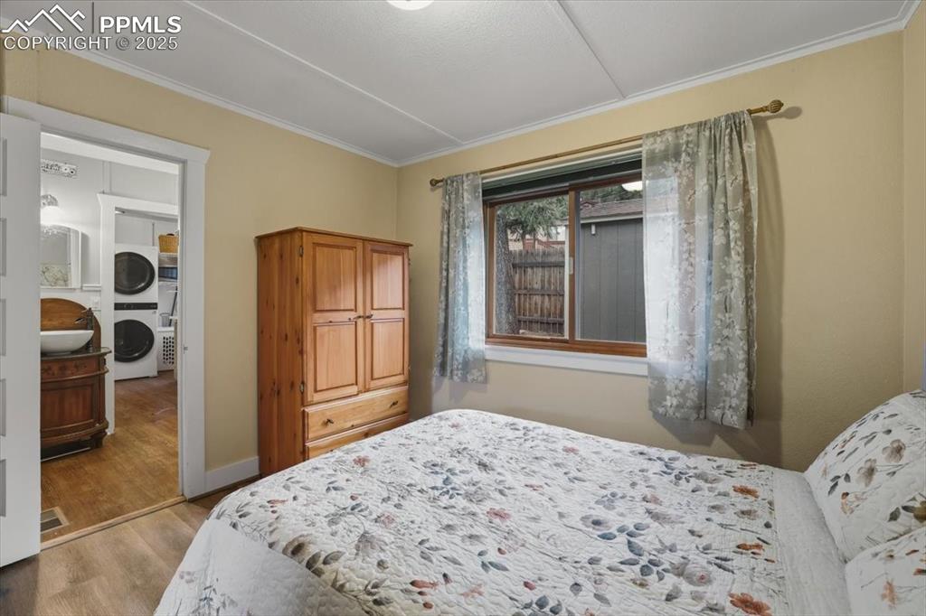 Image 17 of 47: The secondary main-floor bedroom is bright and dreamy and adjacent to the b