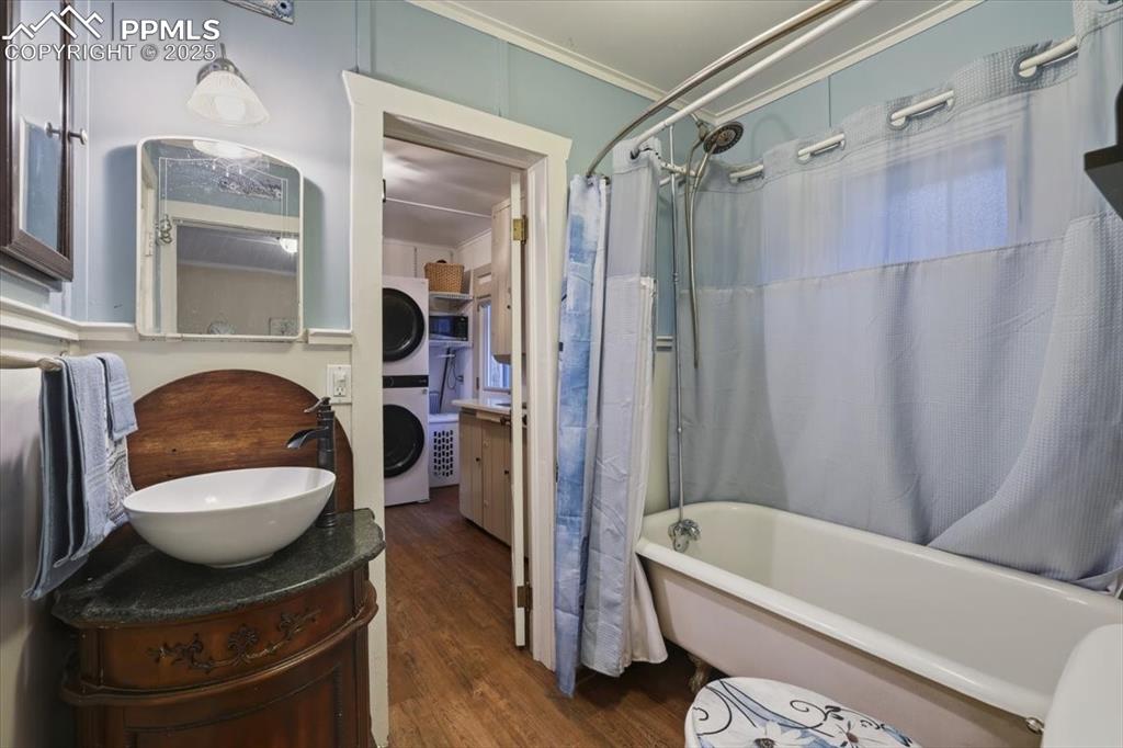 Image 19 of 47: The bathroom features the original claw-foot tub with a new sink and cabine
