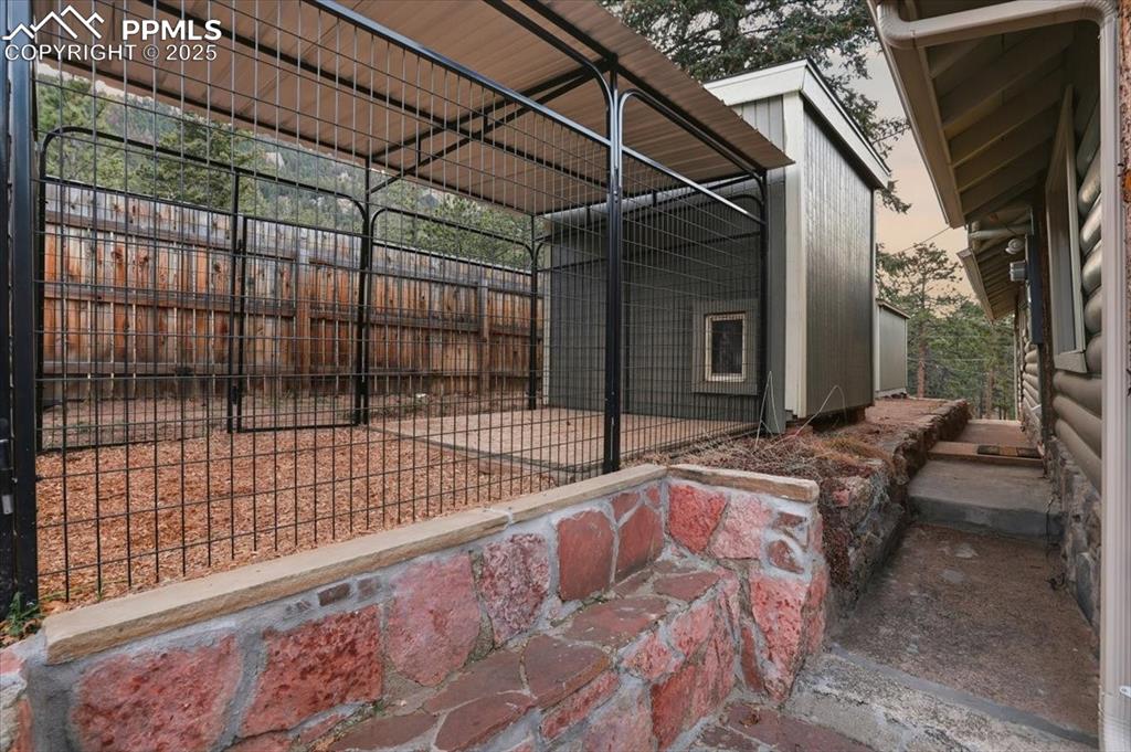 Image 31 of 47: This newer shed is in use as a dog house with an adjacent dog run. You coul
