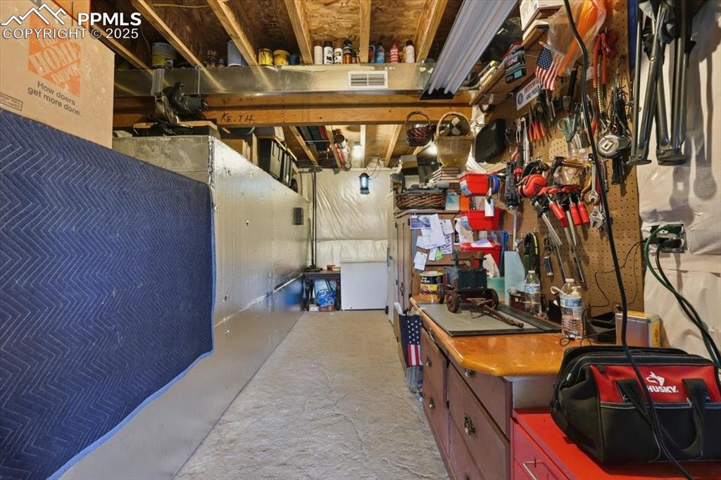 Image 38 of 47: This basement area is in use as an office/workshop and also has room for a 