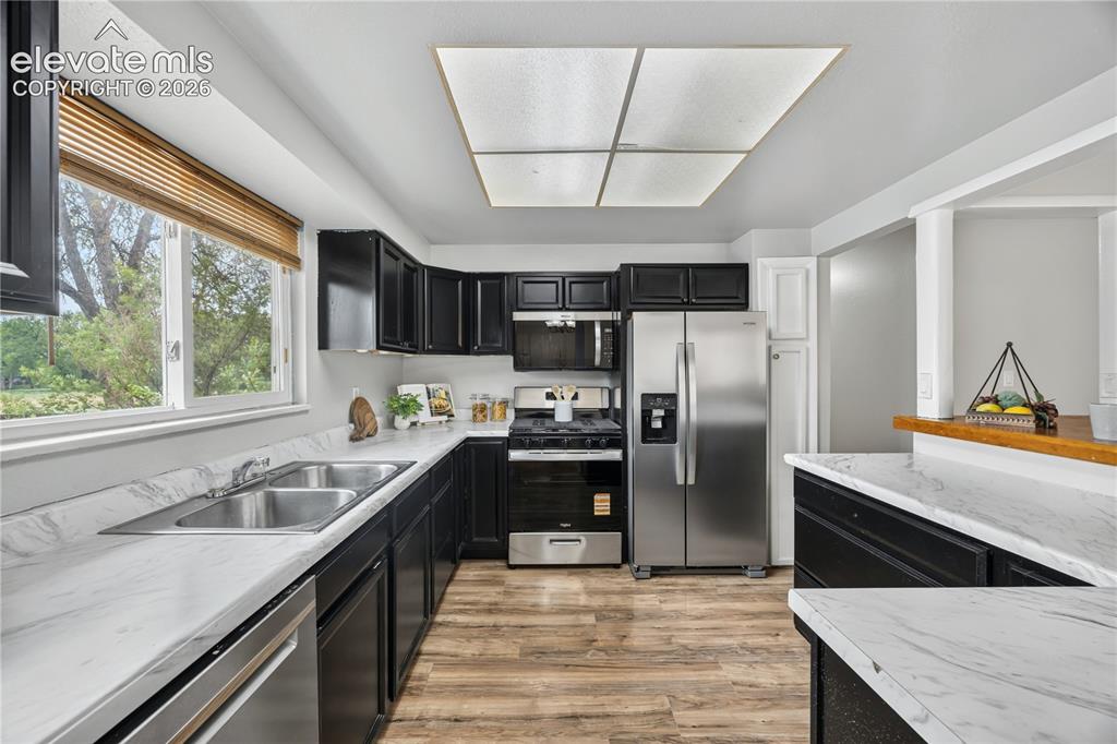 Image 12 of 34: Upper Level Dining Room with hardwood floors, attractive light fixture, and