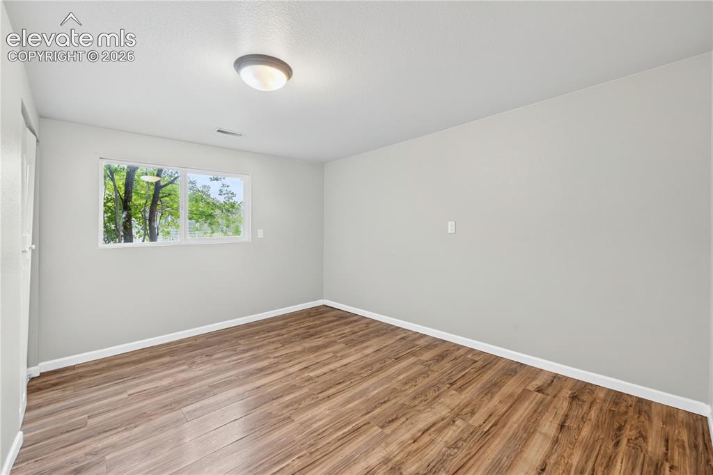 Image 24 of 34: Versatile Lower Level Family/Flex Room with hardwood floors.