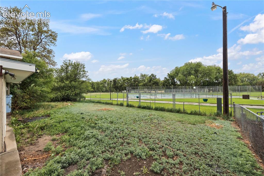 Image 32 of 34: Large backyard with mature trees and plenty of open space. A great setup fo