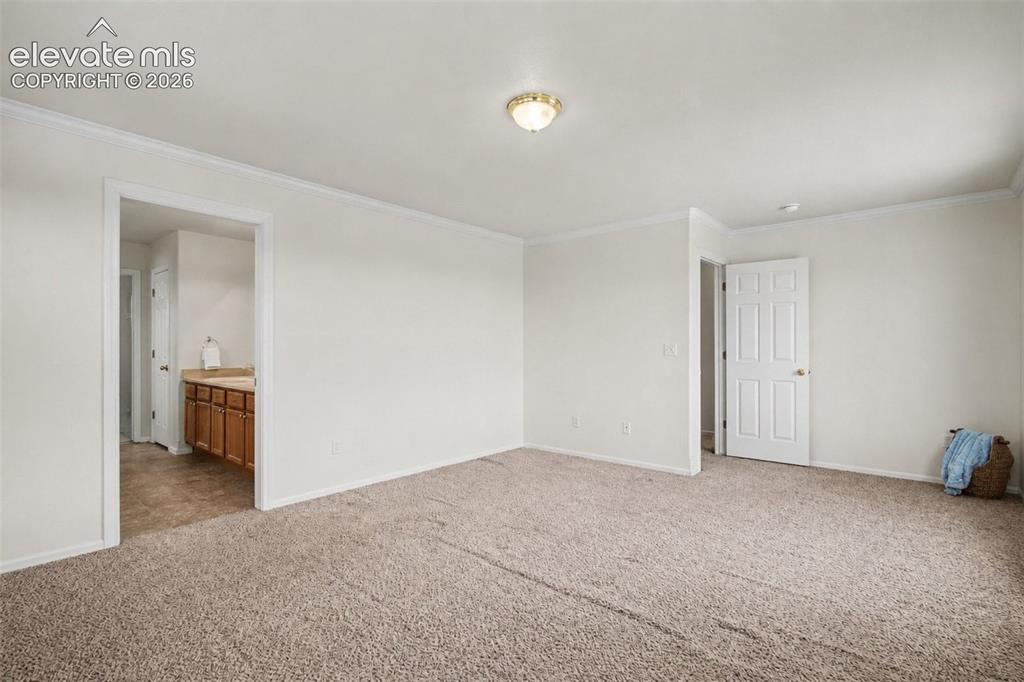 Image 16 of 40: Master bedroom with adjoining bathroom
