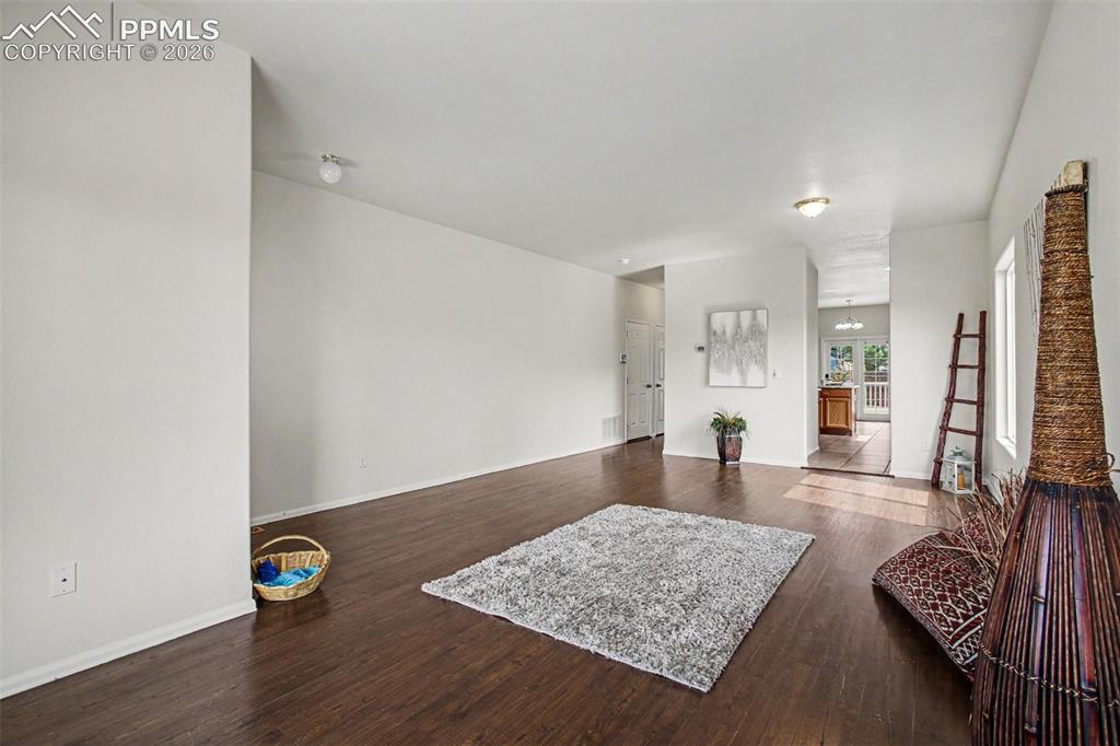 Image 5 of 40: Seamless transition from living room to kitchen