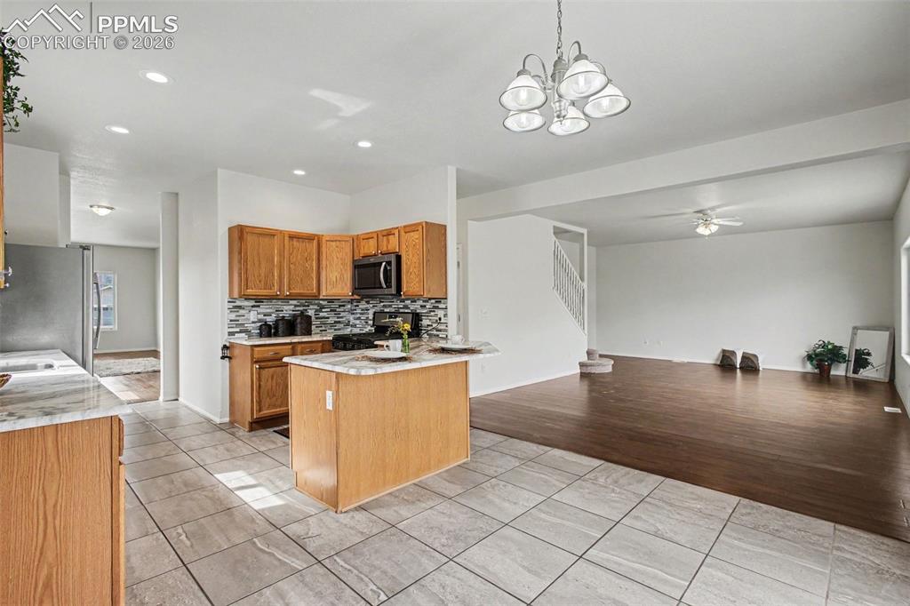 Image 7 of 40: Open kitchen, dining, and family room, perfect for entertaining!