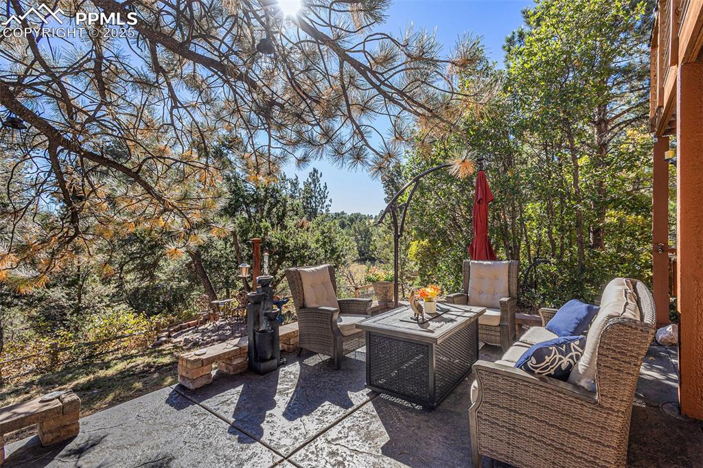 Image 13 of 47: Rear view of property with a patio, stucco siding, an outdoor fire pit, and