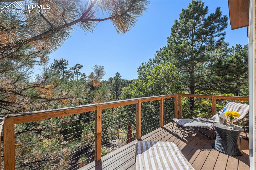 Image 21 of 47: Bathroom featuring a textured wall, double vanity, dark wood-type flooring,