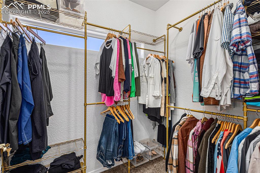 Image 25 of 47: Stairs featuring lofted ceiling, a chandelier, and wood finished floors
