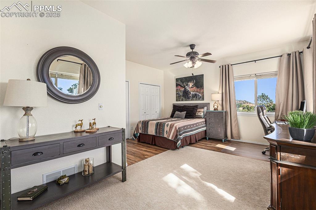 Image 28 of 47: Bedroom featuring dark wood finished floors, a ceiling fan, and a closet