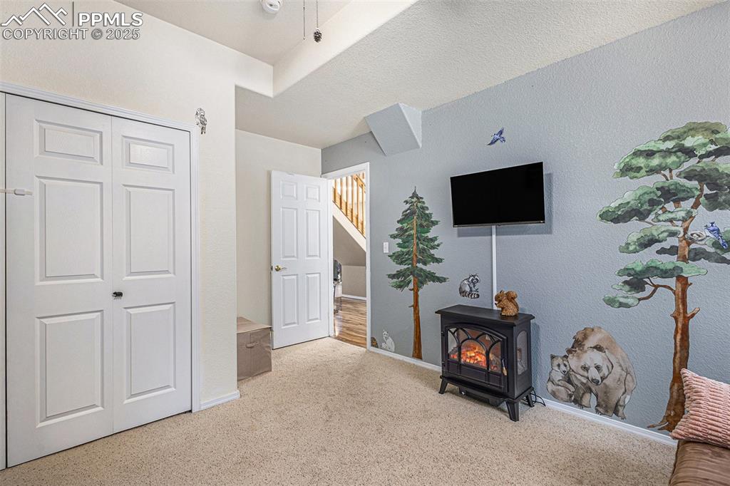 Image 32 of 47: Hallway featuring a skylight, wood finished floors, a chandelier, and high 