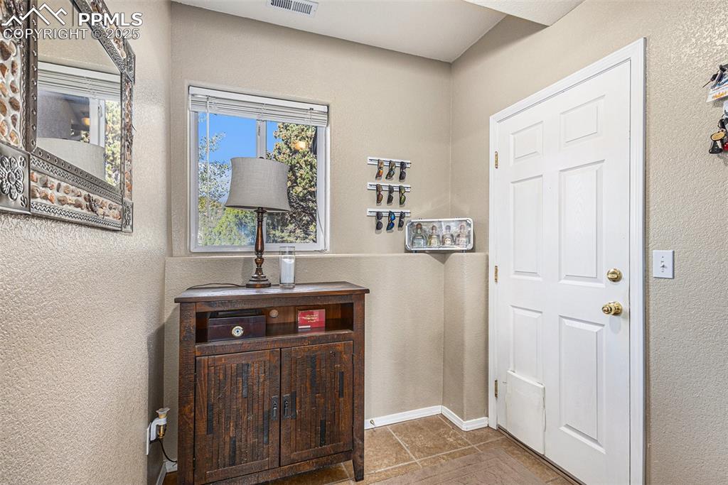 Image 36 of 47: Laundry room featuring washer and dryer, attic access, and a textured wall