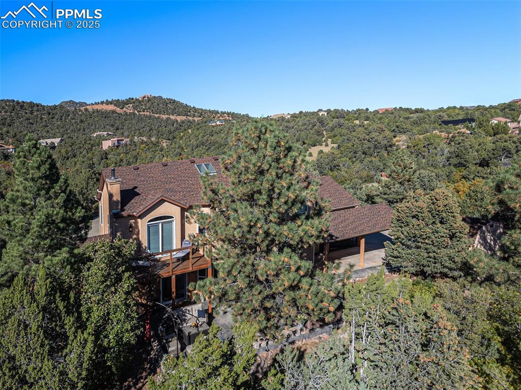 Image 43 of 47: View of subject property with a forest and a mountainous background