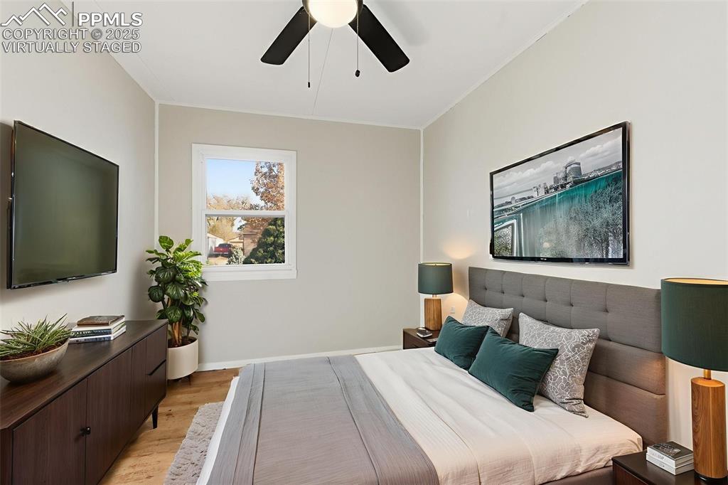 Image 26 of 50: Virtually Staged Bedroom 1 featuring light wood-style flooring and a ceilin