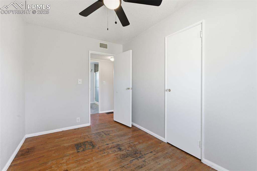 Image 29 of 50: Unfurnished bedroom featuring wood-type flooring and ceiling fan