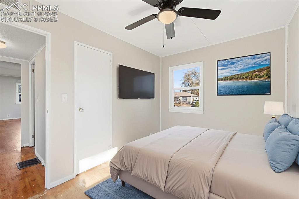 Image 36 of 50: Virtually Staged Bedroom 3 with ceiling fan