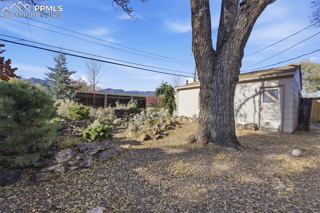 Image 44 of 50: View of yard with an outdoor structure and a mountain view