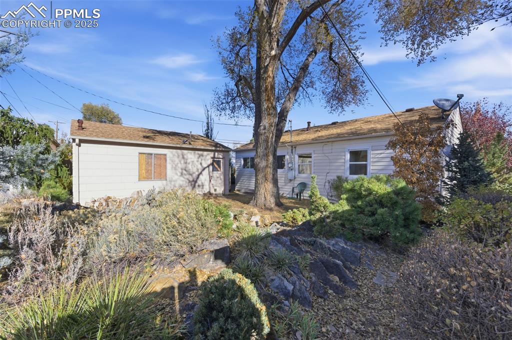 Image 47 of 50: Back of house featuring an outbuilding
