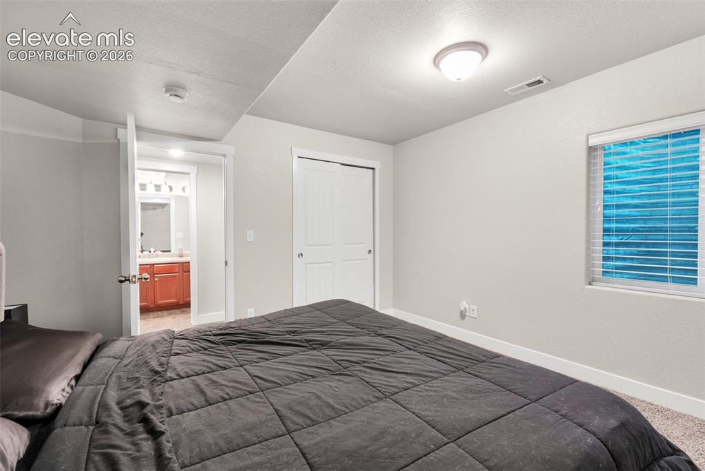 Image 38 of 49: Basement Bedroom