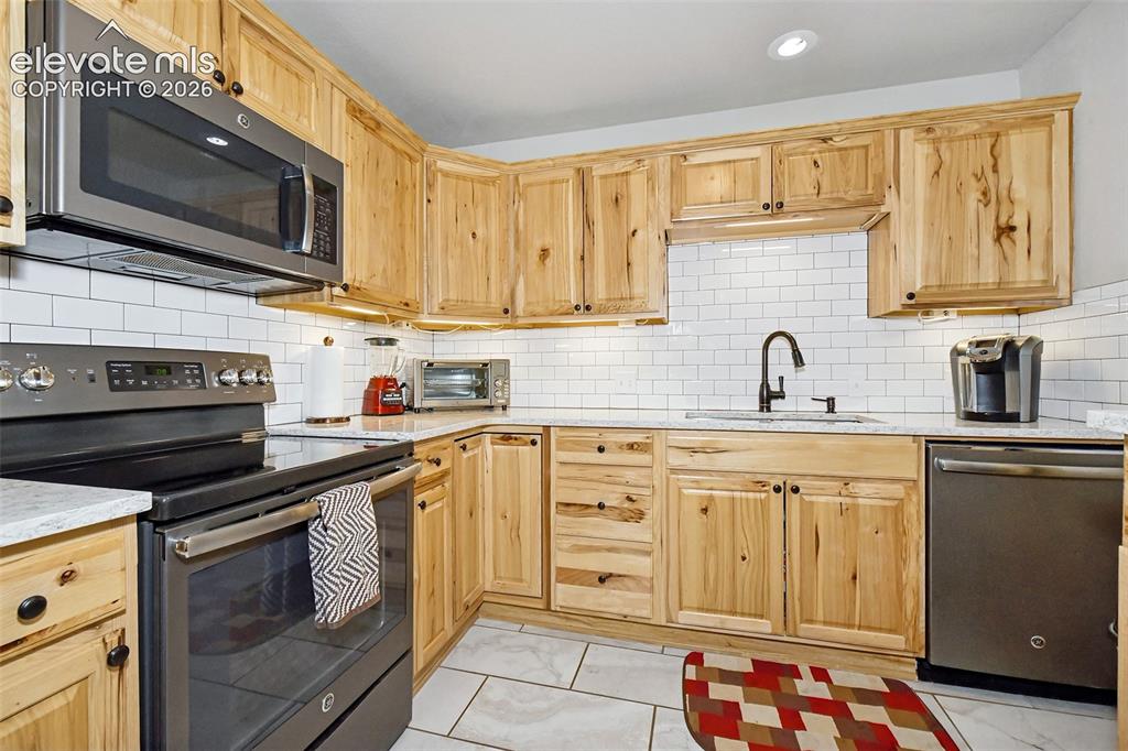 Image 9 of 22: kitchen appliances, cabinets and backsplash