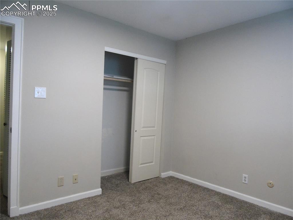 Image 16 of 29: Unfurnished bedroom featuring carpet flooring and a closet