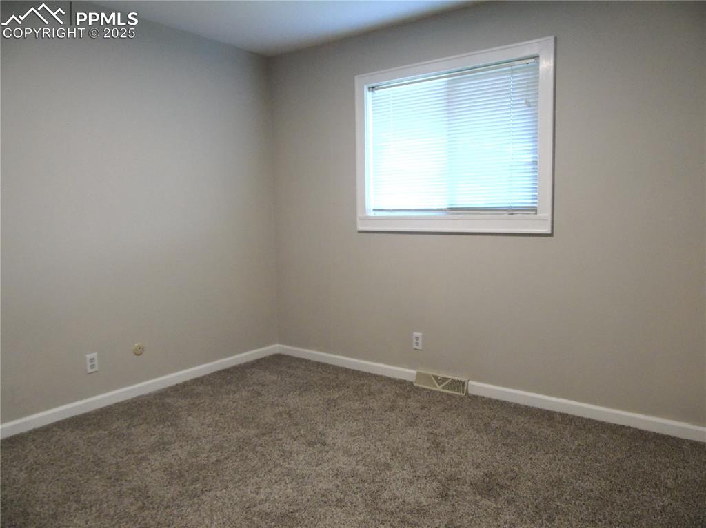 Image 17 of 29: Carpeted empty room with baseboards