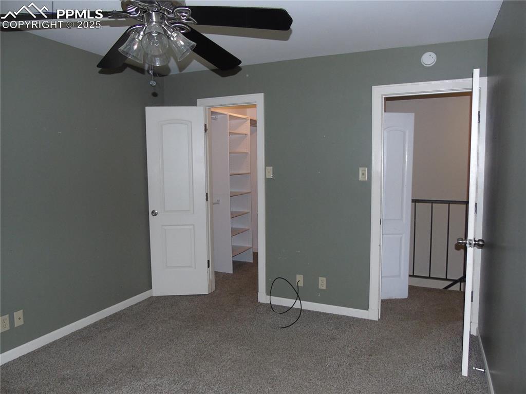 Image 20 of 29: Unfurnished bedroom with carpet flooring, a walk in closet, and a ceiling f