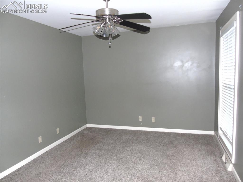 Image 23 of 29: Spare room featuring carpet floors and ceiling fan