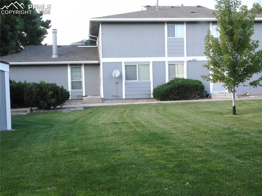 Image 28 of 29: View of front of property with a shingled roof and a front lawn