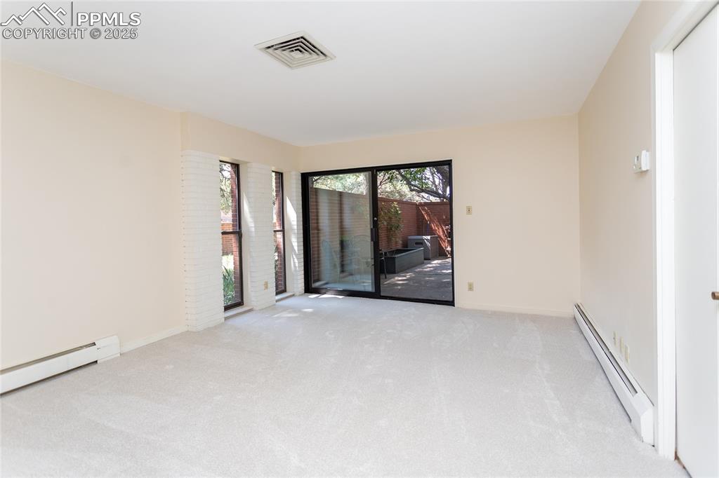 Image 15 of 35: Unfurnished room featuring baseboard heating and carpet flooring