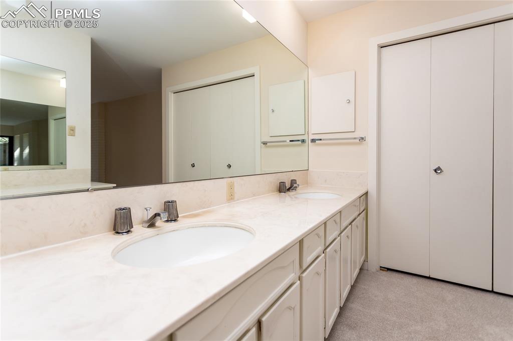Image 20 of 35: Full bathroom featuring double vanity and a closet