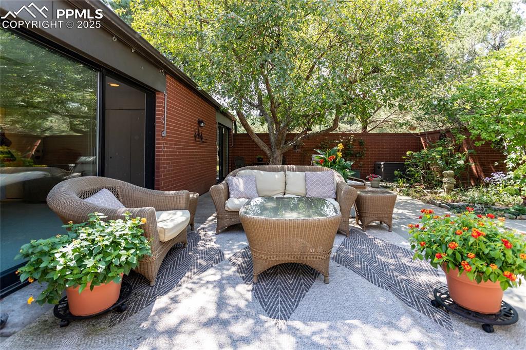 Image 27 of 35: Fenced backyard featuring a patio and outdoor lounge area