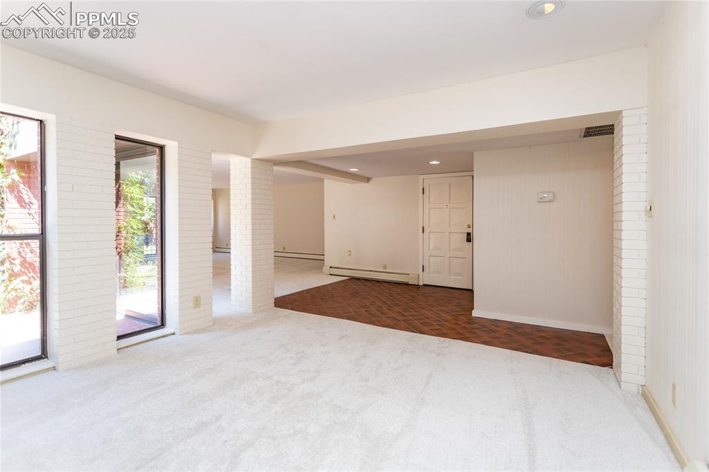 Image 9 of 35: Carpeted spare room with recessed lighting and baseboard heating