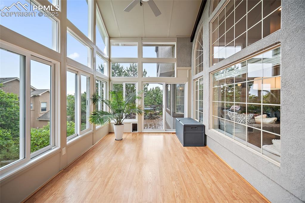 Image 18 of 50: Sunroom with floor to ceiling windows, vaulted ceilings, and access to the 