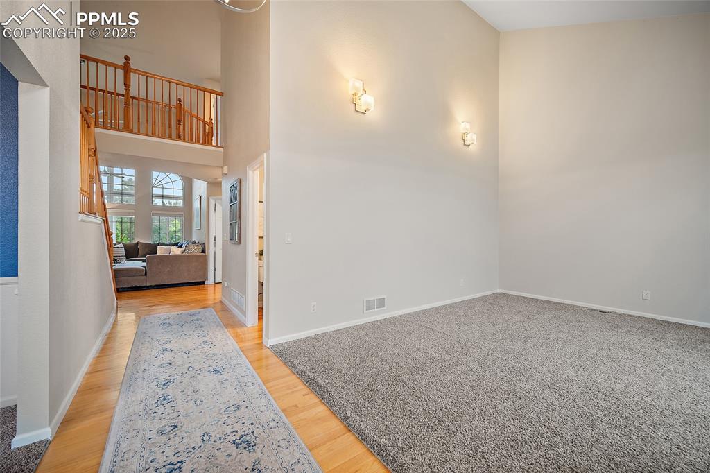 Image 19 of 50: Entry with the family room on the right and formal dining room on the left