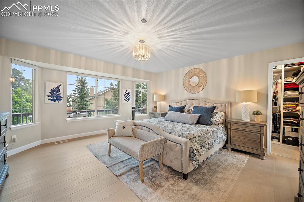 Image 22 of 50: Primary bedroom features LVP, a walk-in closet, and five piece en suite wit