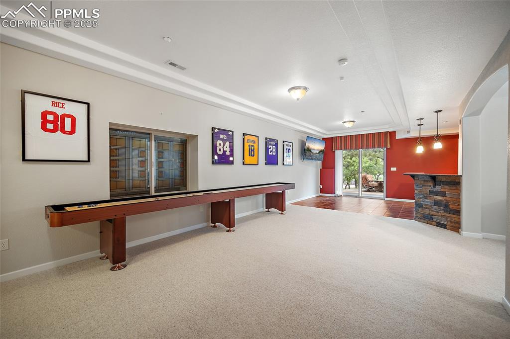 Image 34 of 50: Basement living room with wet bar and walk out