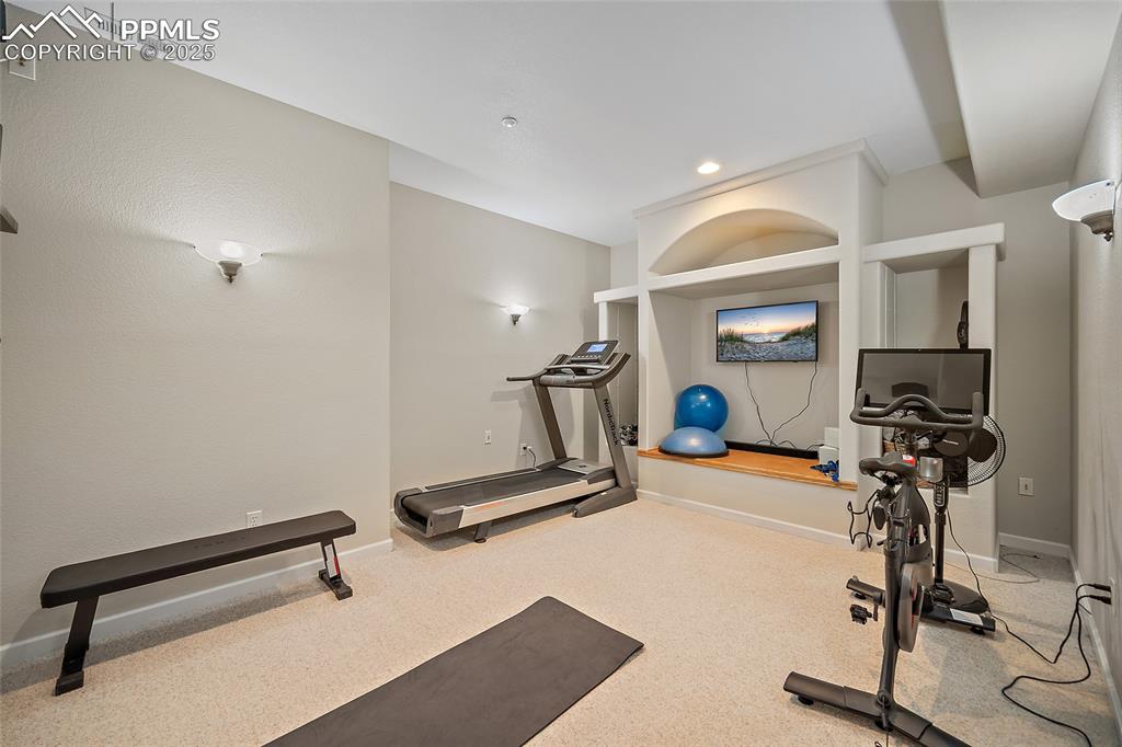 Image 41 of 50: Basement media room / theater turned home gym. 