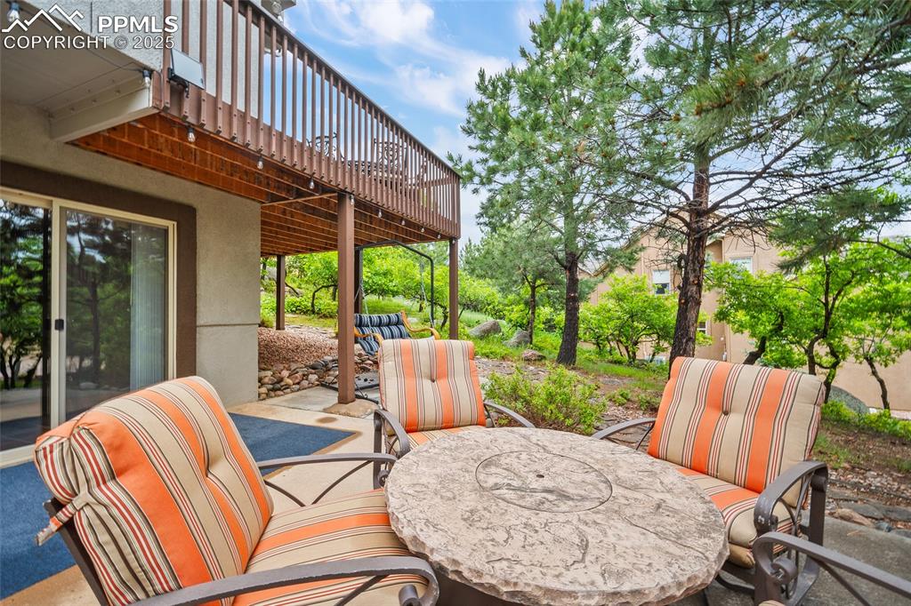 Image 45 of 50: View of patio / terrace with a wooden deck and outdoor dining space