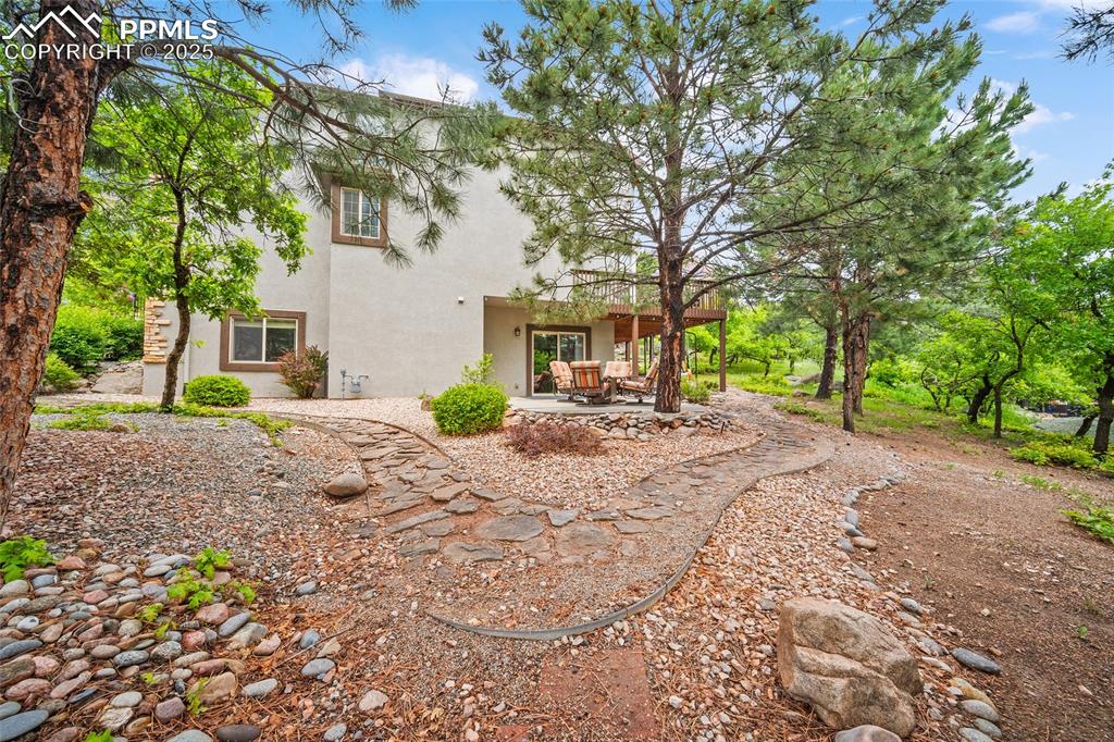 Image 46 of 50: Back of property featuring stucco siding and a patio