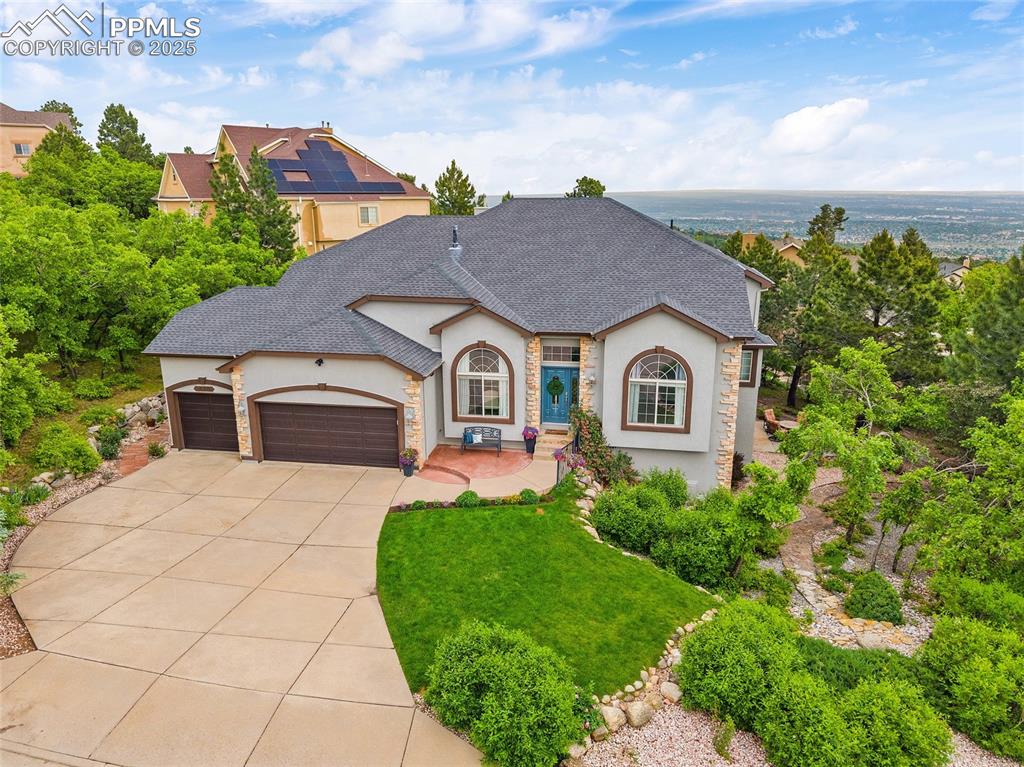 Image 50 of 50: French provincial home featuring stucco siding, a garage, concrete driveway