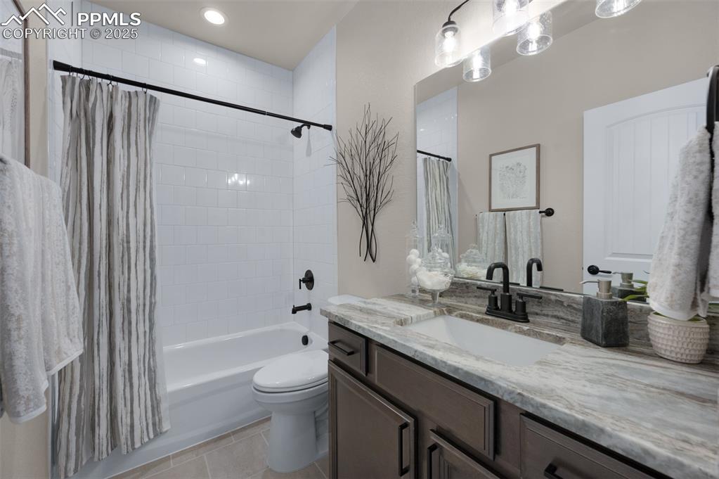 Image 16 of 36: Bathroom with vanity, toilet, recessed lighting, tile patterned floors, and