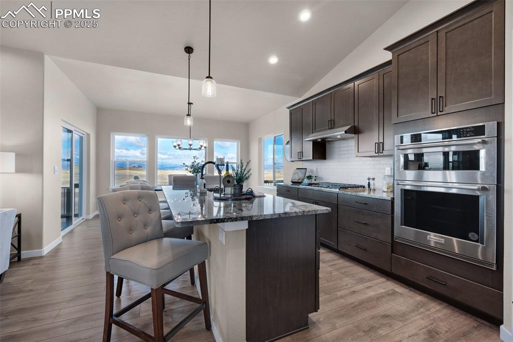 Image 4 of 36: Gourmet kitchen with island and appliances with stainless steel