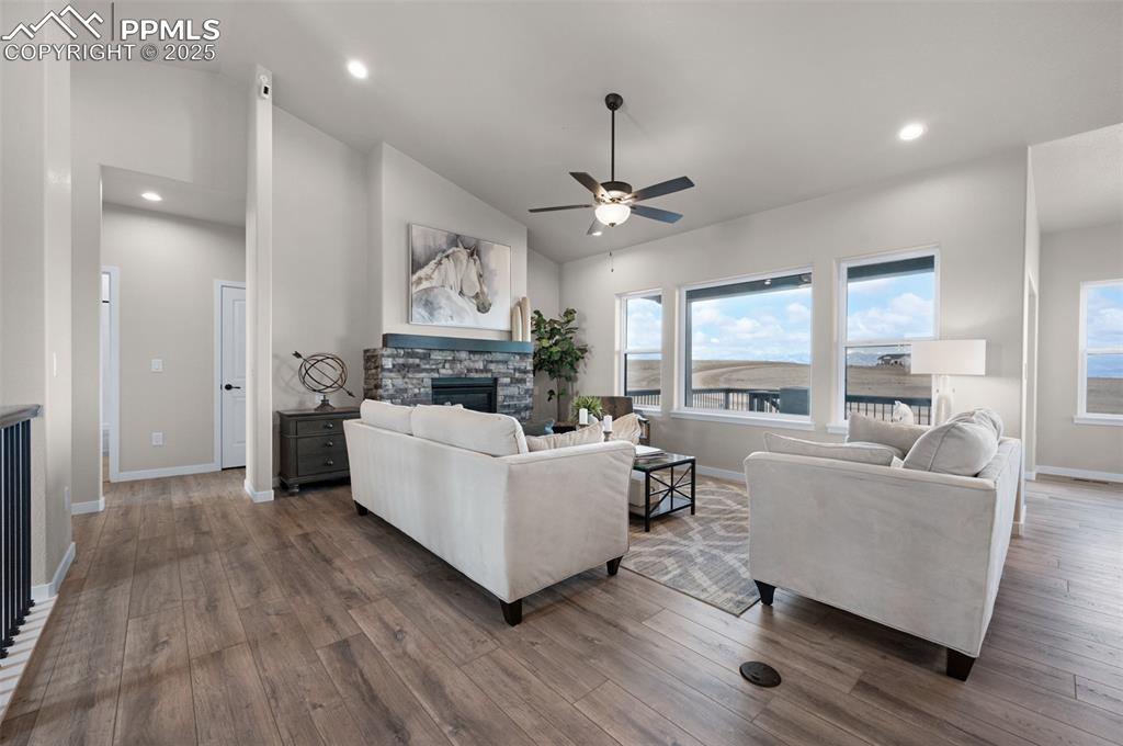 Image 7 of 36: Living room featuring a fireplace, baseboards, dark wood-style floors, rece
